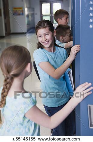 USA, Illinois, Metamora, Schoolchildren (8-9, 10-11) at lockers in school corridor View Large Photo Image Stock Photography - USA, Illinois, Metamora, Schoolchildren (8-9, 10-11) at lockers in school corridor. Fotosearch