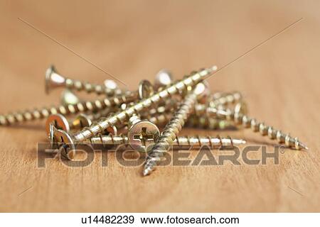 Stock Photo - USA, Illinois, Metamora, Screws on wood. Fotosearch