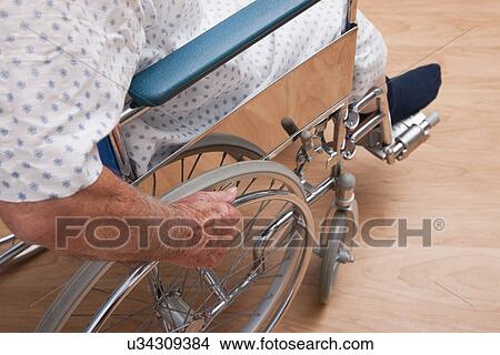 Picture - USA, Illinois, Metamora, Senior man sitting on wheelchair, low section. Fotosearch