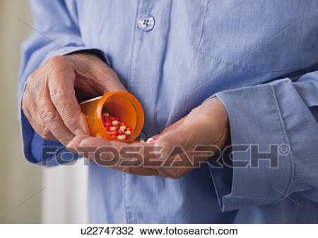 USA, Illinois, Metamora, Senior man pouring pills into hand, mid section View Large Photo Image Stock Image - USA, Illinois, Metamora, Senior man pouring pills into hand, mid section. Fotosearch