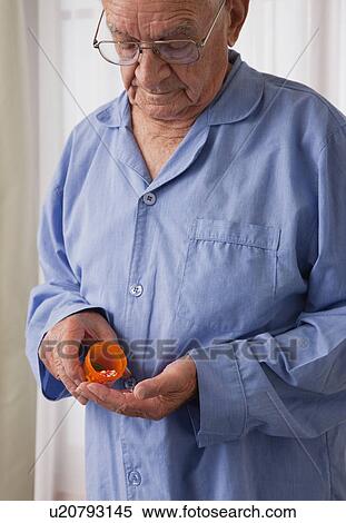 USA, Illinois, Metamora, Senior man pouring pills into hand View Large Photo Image Stock Photography - USA, Illinois, Metamora, Senior man pouring pills into hand. Fotosearch