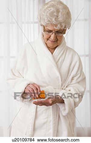 USA, Illinois, Metamora, Senior woman pouring pills into hand View Large Photo Image Picture - USA, Illinois, Metamora, Senior woman pouring pills into hand. Fotosearch