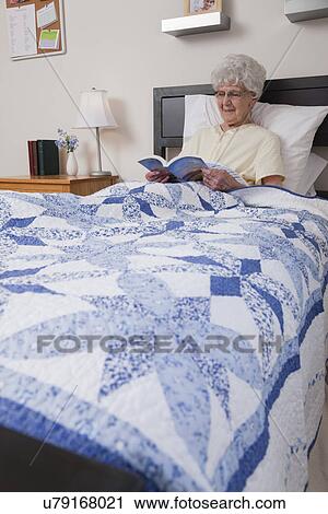 USA, Illinois, Metamora, Senior woman reading book in bed View Large Photo Image Stock Image - USA, Illinois, Metamora, Senior woman reading book in bed. Fotosearch