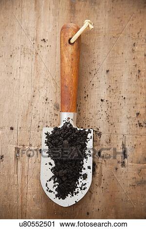 Stock Image - USA, Illinois, Metamora, Shovel with dirt, directly above. Fotosearch