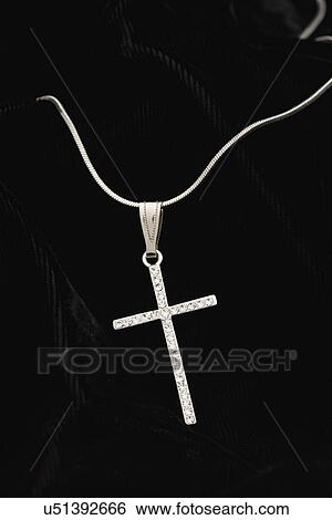 Stock Photograph - USA, Illinois, Metamora, Silver cross religious necklace. Fotosearch
