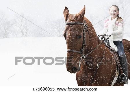 USA, Illinois, Metamora, Smiling girl (10-11) riding horse during winter View Large Photo Image Stock Photography - USA, Illinois, Metamora, Smiling girl (10-11) riding horse during winter. Fotosearch
