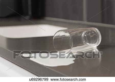 Stock Photo - USA, Illinois, Metamora, Spilt glass of milk. Fotosearch
