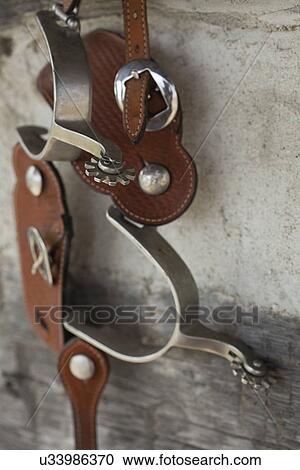 Stock Image - USA, Illinois, Metamora, Spurs hanging outdoors. Fotosearch