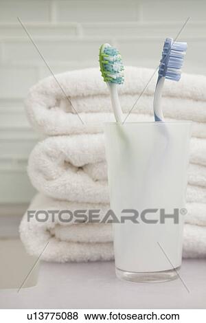 USA, Illinois, Metamora, stack of towels and toothbrush in holder View Large Photo Image Stock Photo - USA, Illinois, Metamora, stack of towels and toothbrush in holder. Fotosearch