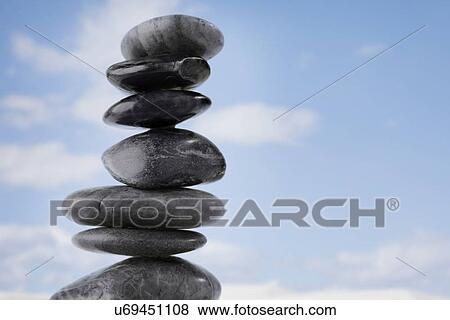 USA, Illinois, Metamora, stack of pebbles against sky View Large Photo Image Stock Photo - USA, Illinois, Metamora, stack of pebbles against sky. Fotosearch