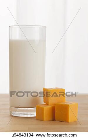 USA, Illinois, Metamora, Stacked cheese beside glass of milk View Large Photo Image Picture - USA, Illinois, Metamora, Stacked cheese beside glass of milk. Fotosearch