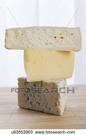 Stock Image - USA, Illinois, Metamora, Stacked cheeses on table. Fotosearch