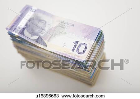 Stock Image - USA, Illinois, Metamora, Studio shot of stack of Canadian banknotes. Fotosearch