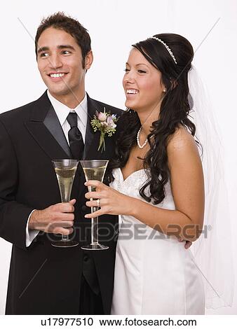 USA, Illinois, Metamora, Studio shot of bride and groom holding champagne flutes View Large Photo Image Stock Image - USA, Illinois, Metamora, Studio shot of bride and groom holding champagne flutes. Fotosearch