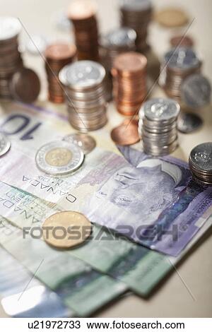 USA, Illinois, Metamora, Studio shot of Canadian banknotes and stacks of coins View Large Photo Image Stock Image - USA, Illinois, Metamora, Studio shot of Canadian banknotes and stacks of coins. Fotosearch