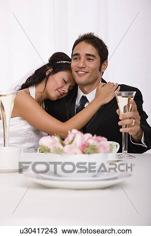Stock Image - USA, Illinois, Metamora, Studio shot of bride and groom. Fotosearch