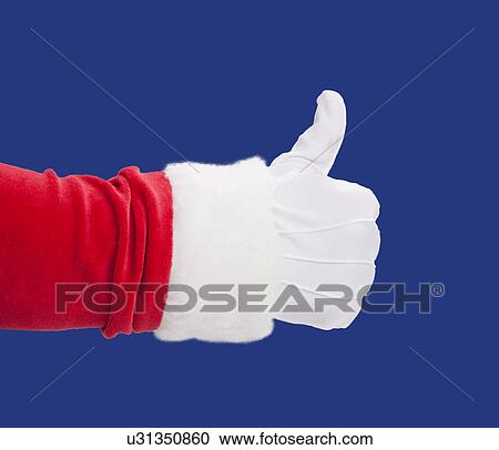 Stock Image - USA, Illinois, Metamora, Studio shot of Santa's hand with thumbs up against blue background. Fotosearch