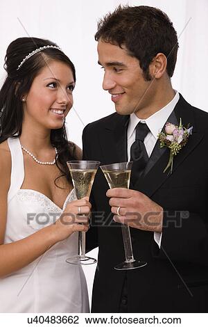 USA, Illinois, Metamora, Studio shot of bride and groom toasting with champagne View Large Photo Image Stock Image - USA, Illinois, Metamora, Studio shot of bride and groom toasting with champagne. Fotosearch