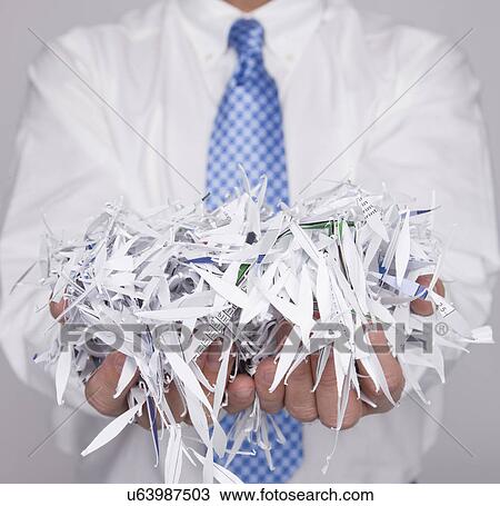 USA, Illinois, Metamora, Studio shot of man holding pile of shredded paper, mid section View Large Photo Image Stock Image - USA, Illinois, Metamora, Studio shot of man holding pile of shredded paper, mid section. Fotosearch