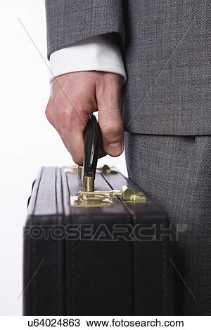 USA, Illinois, Metamora, Studio shot of man in full suit holding briefcase, close-up of hand View Large Photo Image Stock Image - USA, Illinois, Metamora, Studio shot of man in full suit holding briefcase, close-up of hand. Fotosearch