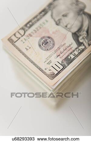 Stock Image - USA, Illinois, Metamora, Studio shot of stack of American banknotes. Fotosearch