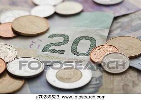 Stock Image - USA, Illinois, Metamora, Studio shot of Canadian banknotes and coins. Fotosearch