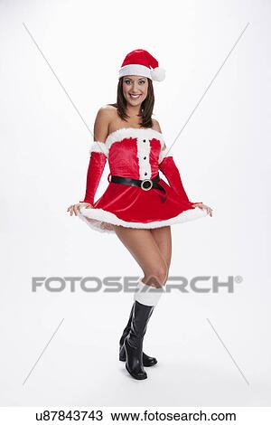 Stock Image - USA, Illinois, Metamora, Studio shot of woman wearing Santa costume. Fotosearch