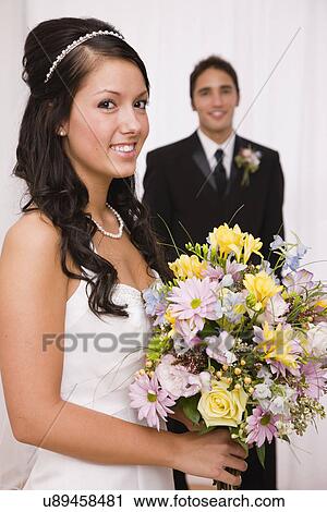 Stock Image - USA, Illinois, Metamora, Studio shot of bride and groom. Fotosearch