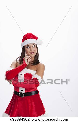 Stock Image - USA, Illinois, Metamora, Studio shot of woman wearing Santa costume. Fotosearch