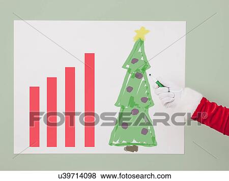 Stock Photo - USA, Illinois, Metamora, Studio shot of Santa's hand drawing Christams tree at progress chart. Fotosearch