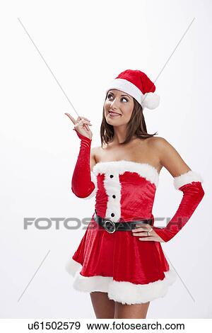 Stock Photo - USA, Illinois, Metamora, Studio shot of woman wearing Santa costume. Fotosearch
