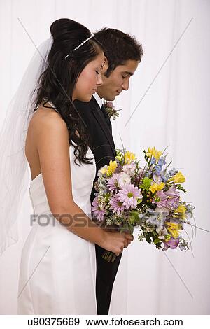 USA, Illinois, Metamora, Studio shot of bride and groom View Large Photo Image Stock Photo - USA, Illinois, Metamora, Studio shot of bride and groom. Fotosearch