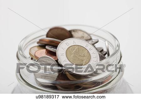 USA, Illinois, Metamora, Studio shot of Canadian coins in jar View Large Photo Image Stock Photo - USA, Illinois, Metamora, Studio shot of Canadian coins in jar. Fotosearch