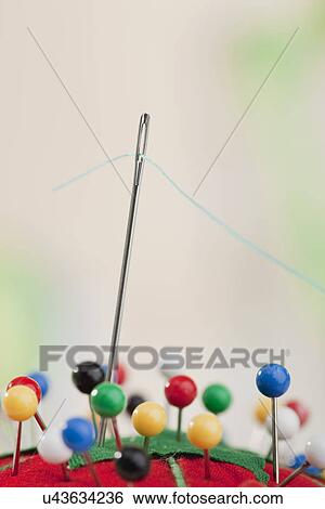 USA, Illinois, Metamora, studio shot of needle and blue thread in pin cushion View Large Photo Image Stock Photograph - USA, Illinois, Metamora, studio shot of needle and blue thread in pin cushion. Fotosearch