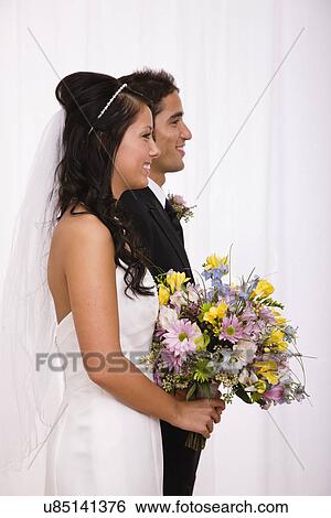 USA, Illinois, Metamora, Studio shot of bride and groom View Large Photo Image Stock Photograph - USA, Illinois, Metamora, Studio shot of bride and groom. Fotosearch