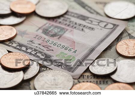 Stock Photography - USA, Illinois, Metamora, Studio shot of American banknotes and coins. Fotosearch