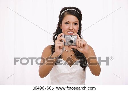 USA, Illinois, Metamora, Studio shot of bride using digital camera View Large Photo Image Stock Photography - USA, Illinois, Metamora, Studio shot of bride using digital camera. Fotosearch