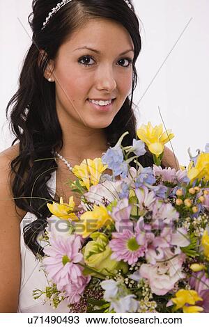 USA, Illinois, Metamora, Studio portrait of bride holding bouquet View Large Photo Image Stock Image - USA, Illinois, Metamora, Studio portrait of bride holding bouquet. Fotosearch