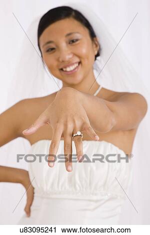 USA, Illinois, Metamora, Studio portrait of bride showing wedding ring View Large Photo Image Stock Image - USA, Illinois, Metamora, Studio portrait of bride showing wedding ring. Fotosearch