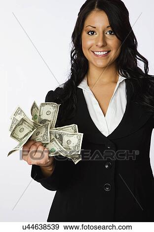 USA, Illinois, Metamora, Studio portrait of business woman holding dollar bills View Large Photo Image Stock Photo - USA, Illinois, Metamora, Studio portrait of business woman holding dollar bills. Fotosearch