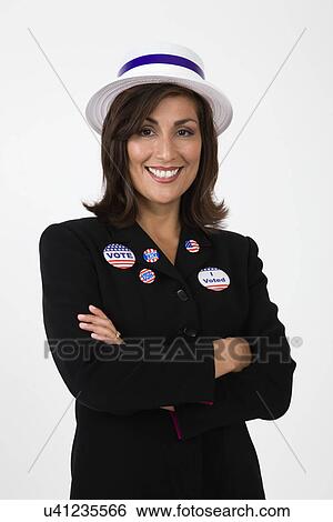 USA, Illinois, Metamora, Studio portrait of smiling woman wearing hat and vote buttons View Large Photo Image Stock Photograph - USA, Illinois, Metamora, Studio portrait of smiling woman wearing hat and vote buttons. Fotosearch