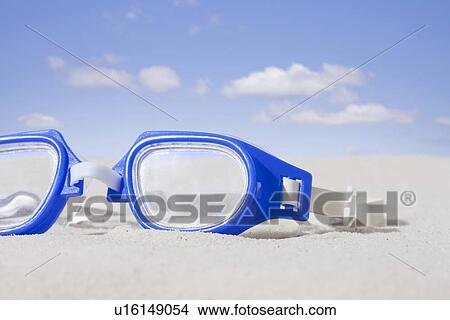 Picture - USA, Illinois, Metamora, Swimming goggles on sand. Fotosearch