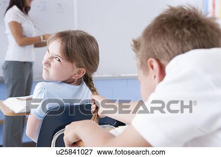 USA, Illinois, Metamora, Teacher and students (8-9) in classroom, boy bullying girl View Large Photo Image Stock Photo - USA, Illinois, Metamora, Teacher and students (8-9) in classroom, boy bullying girl. Fotosearch