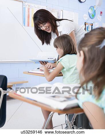 Stock Photograph - USA, Illinois, Metamora, Teacher and students (8-9) in classroom. Fotosearch