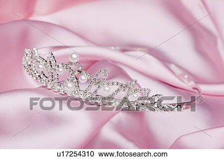 Stock Image - USA, Illinois, Metamora, Tiara on pink fabric. Fotosearch