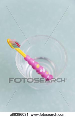 Stock Image - USA, Illinois, Metamora, toothbrush in glass. Fotosearch