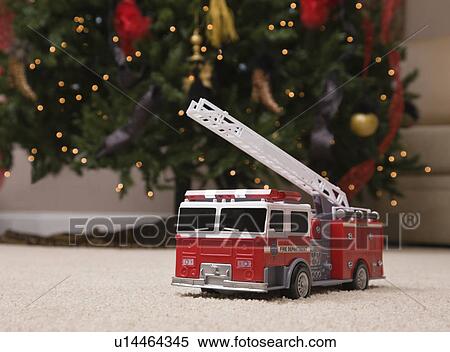 USA, Illinois, Metamora, toy truck under Christmas tree View Large Photo Image Stock Photography - USA, Illinois, Metamora, toy truck under Christmas tree. Fotosearch