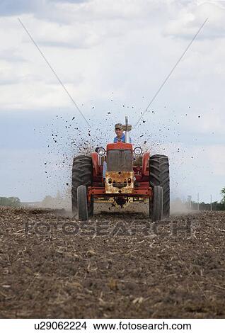 Picture - USA, Illinois, Metamora, tractor working on field. Fotosearch
