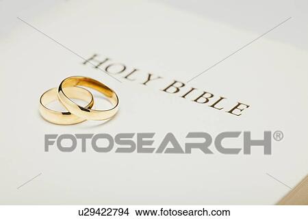 USA, Illinois, Metamora, Two wedding rings on dictionary View Large Photo Image Picture - USA, Illinois, Metamora, Two wedding rings on dictionary. Fotosearch