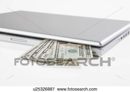 Stock Photo - USA, Illinois, Metamora, US money coming out of laptop computer. Fotosearch